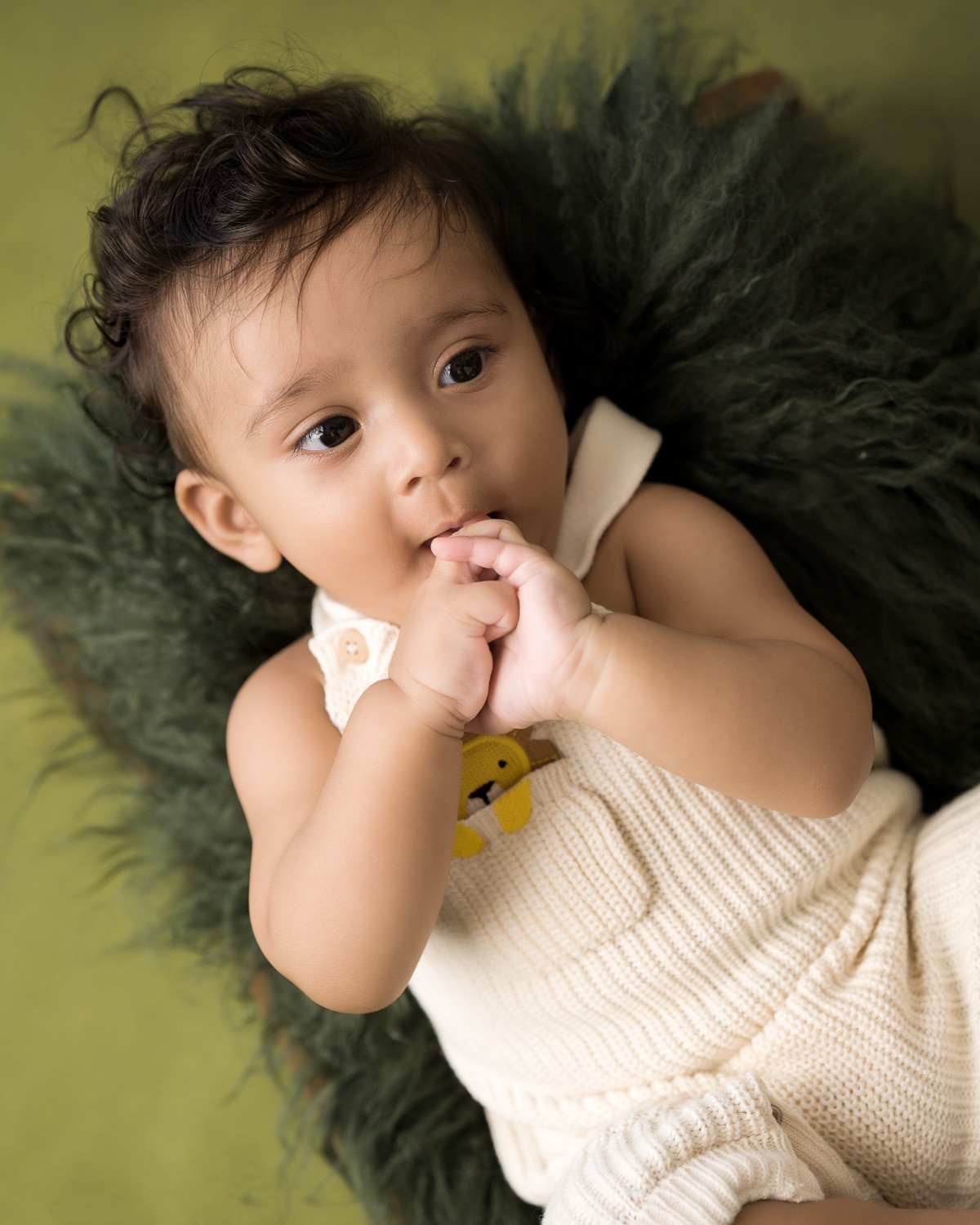 Baby resting on a soft green blanket