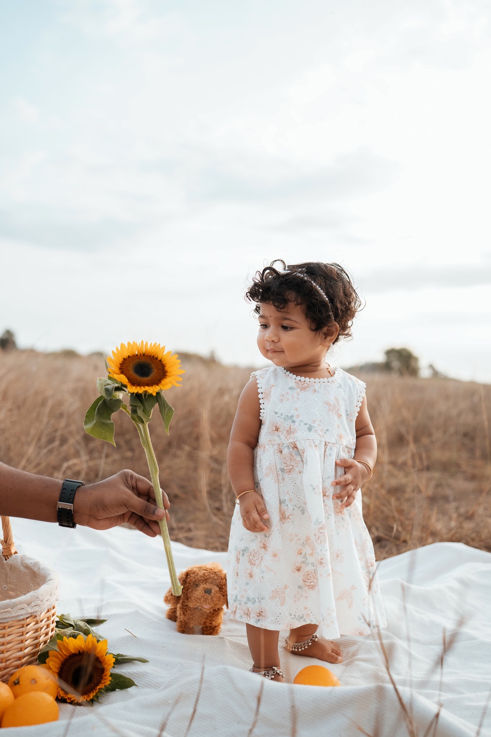 Toddler with a sunflower during an outdoor shoot