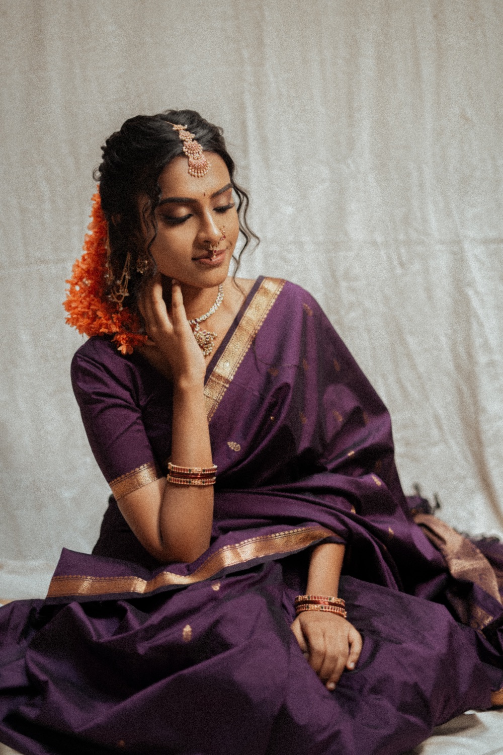 Portrait in a purple saree with flowers in her hair