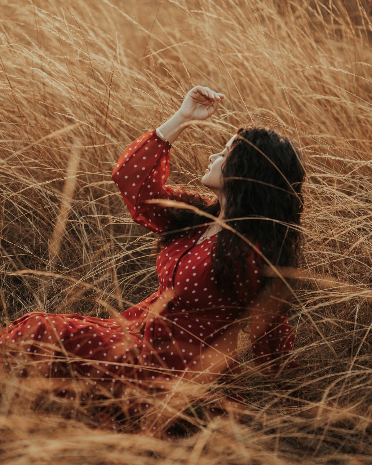 Portrait seated among tall golden grass